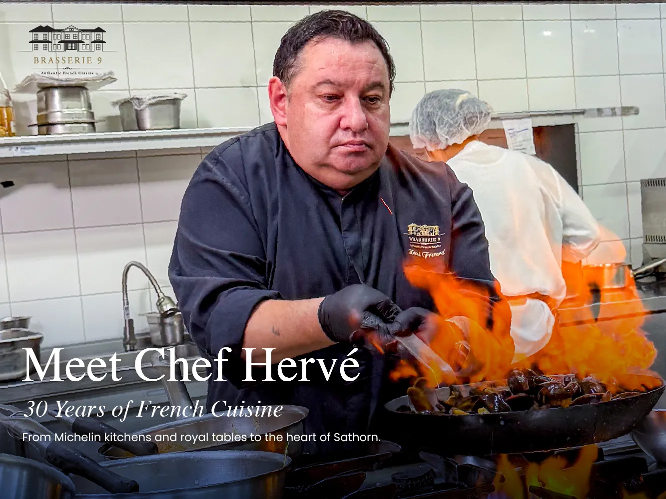 Chef Hervé Frérard flambeing a dish in the kitchen at Brasserie 9, Sathorn Bangkok