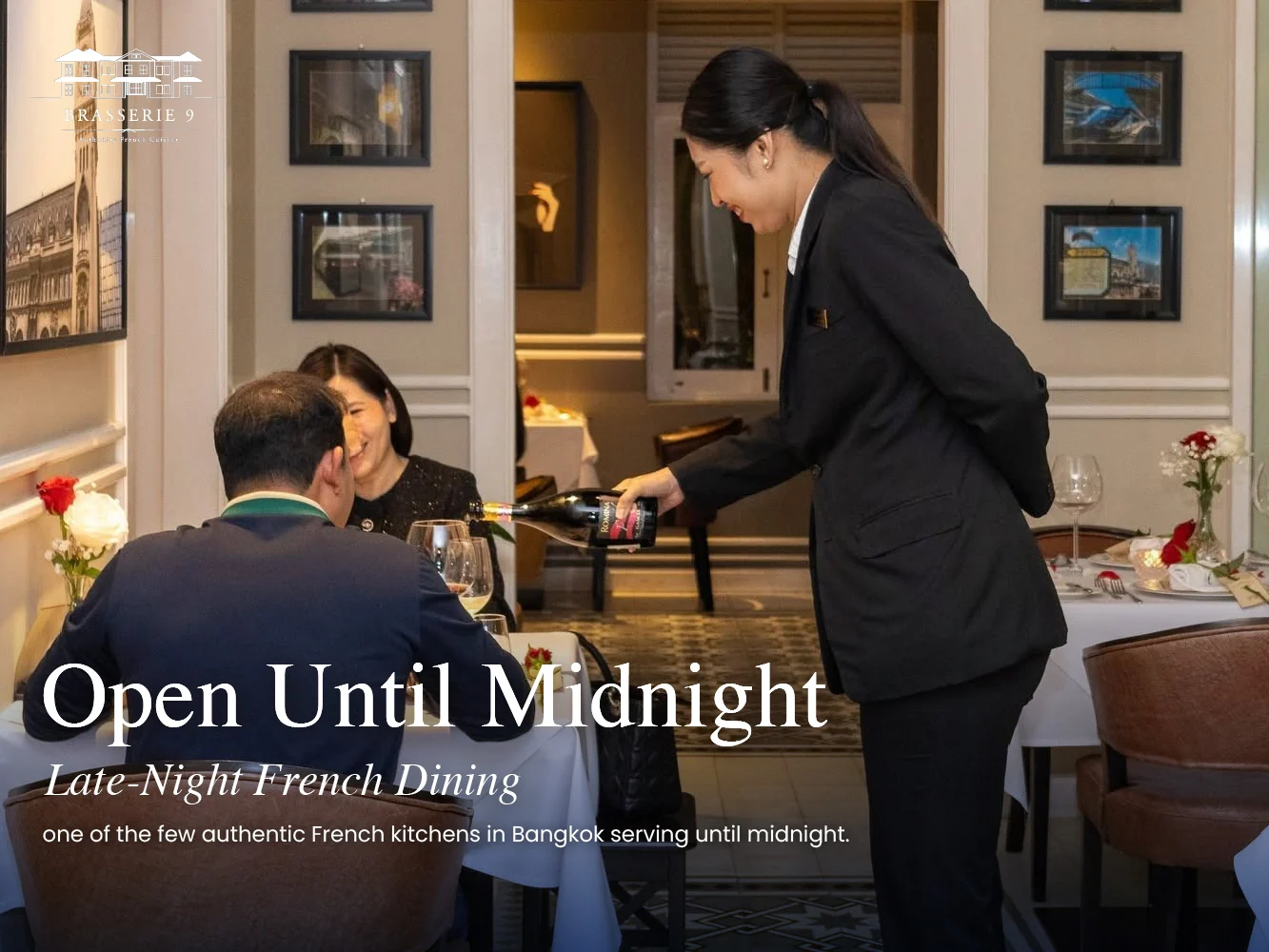 A Brasserie 9 server pours wine for two guests in the dining room of the French restaurant in Sathorn, Bangkok