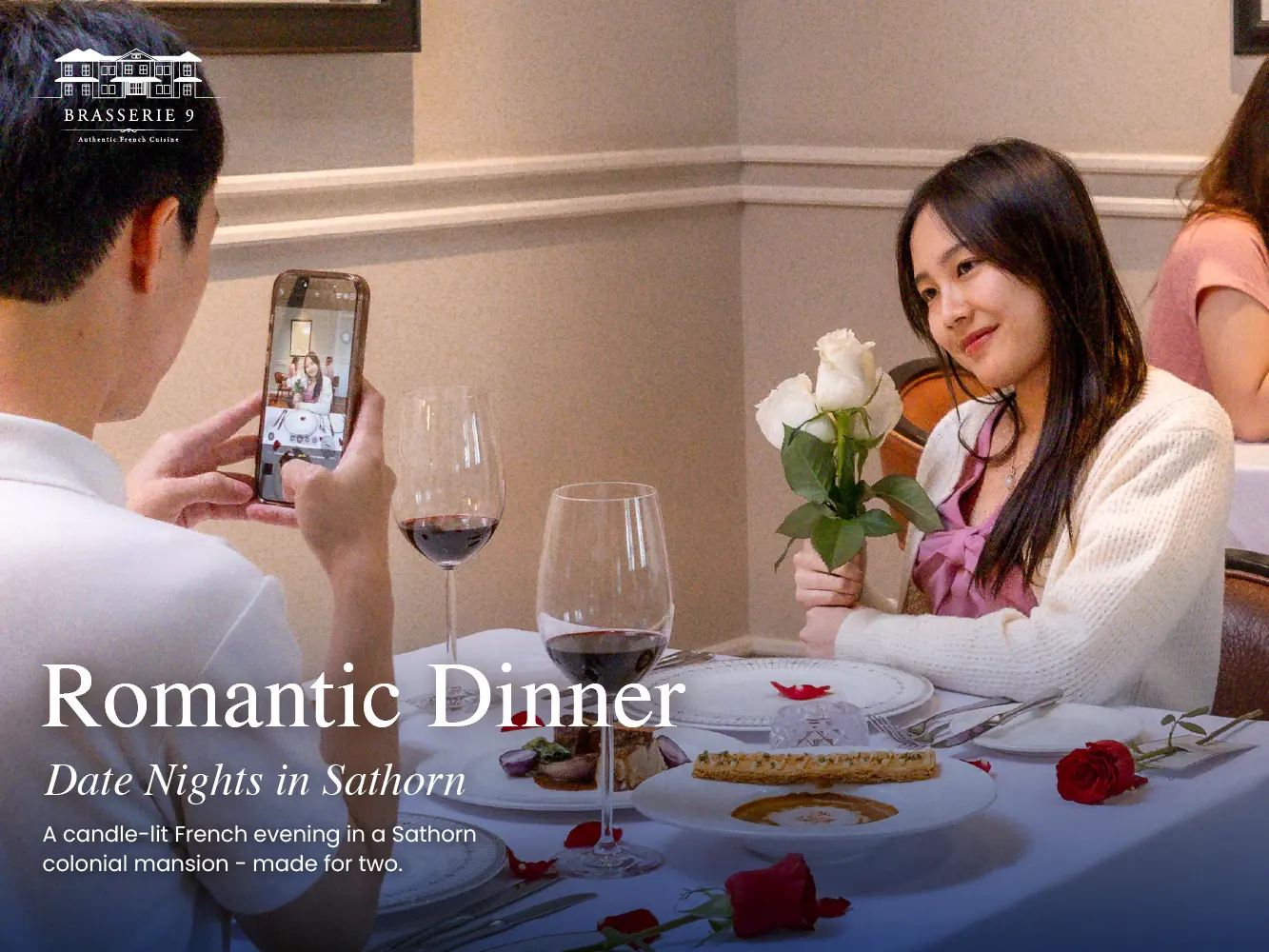 A couple on a dinner date at Brasserie 9 in Sathorn, Bangkok, with white roses, red wine and rose petals on the table